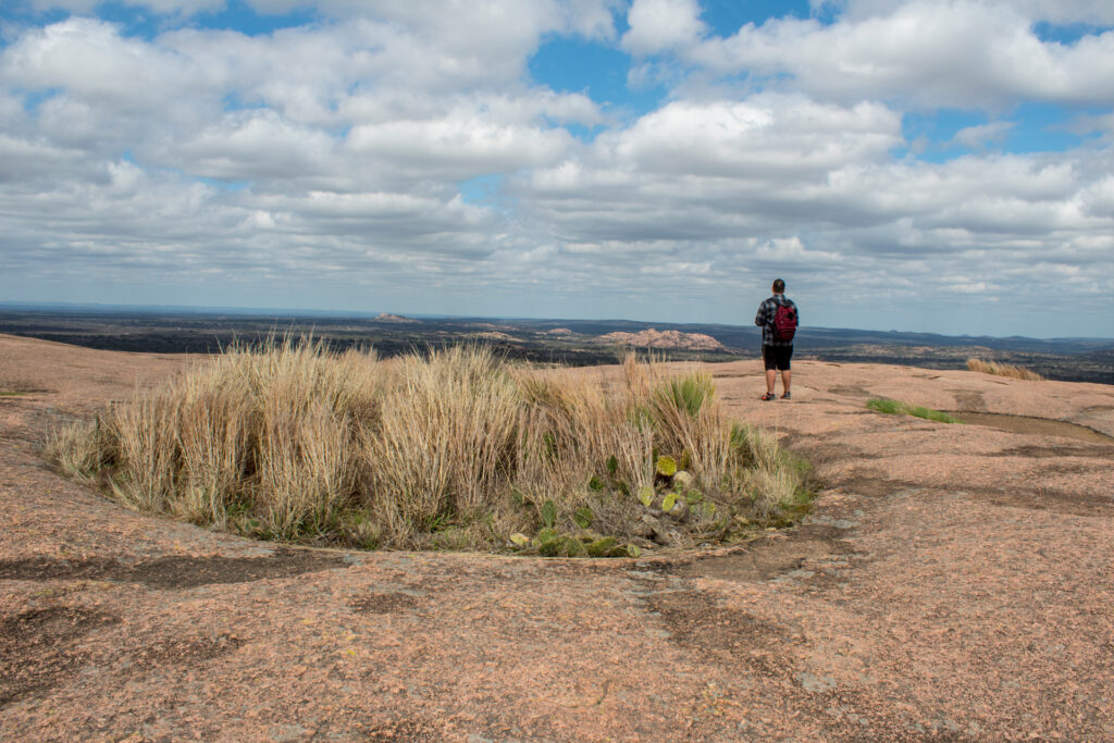 Hiker standing overlooking edge of Enchanted Rock